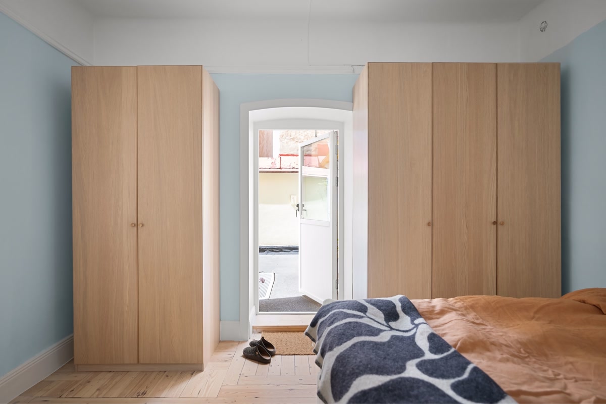 Bedroom with organized shoe storage and dog bed, cords managed