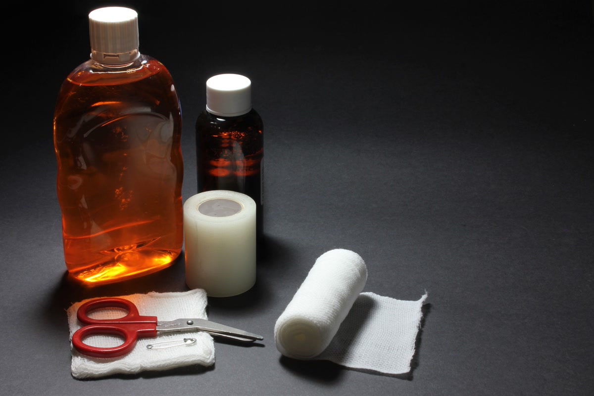 DIY pet first aid kit with gauze bandages and supplies spread on table