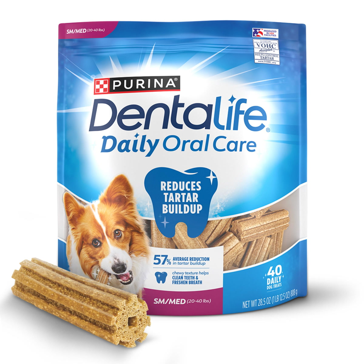 assortment of dog dental chew treats on wooden board overhead view