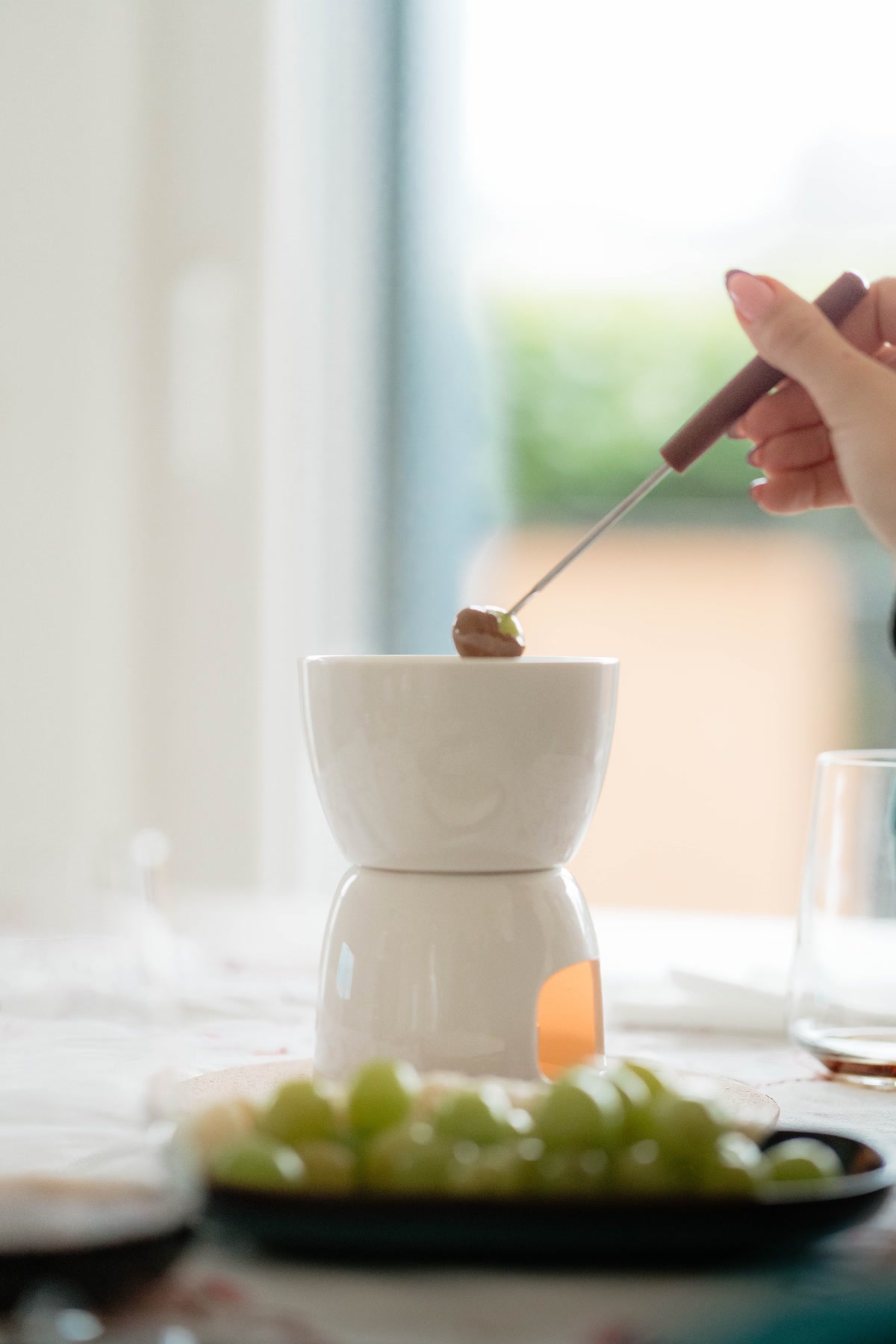 Chocolate fondue with grapes showing foods toxic to dogs during holidays
