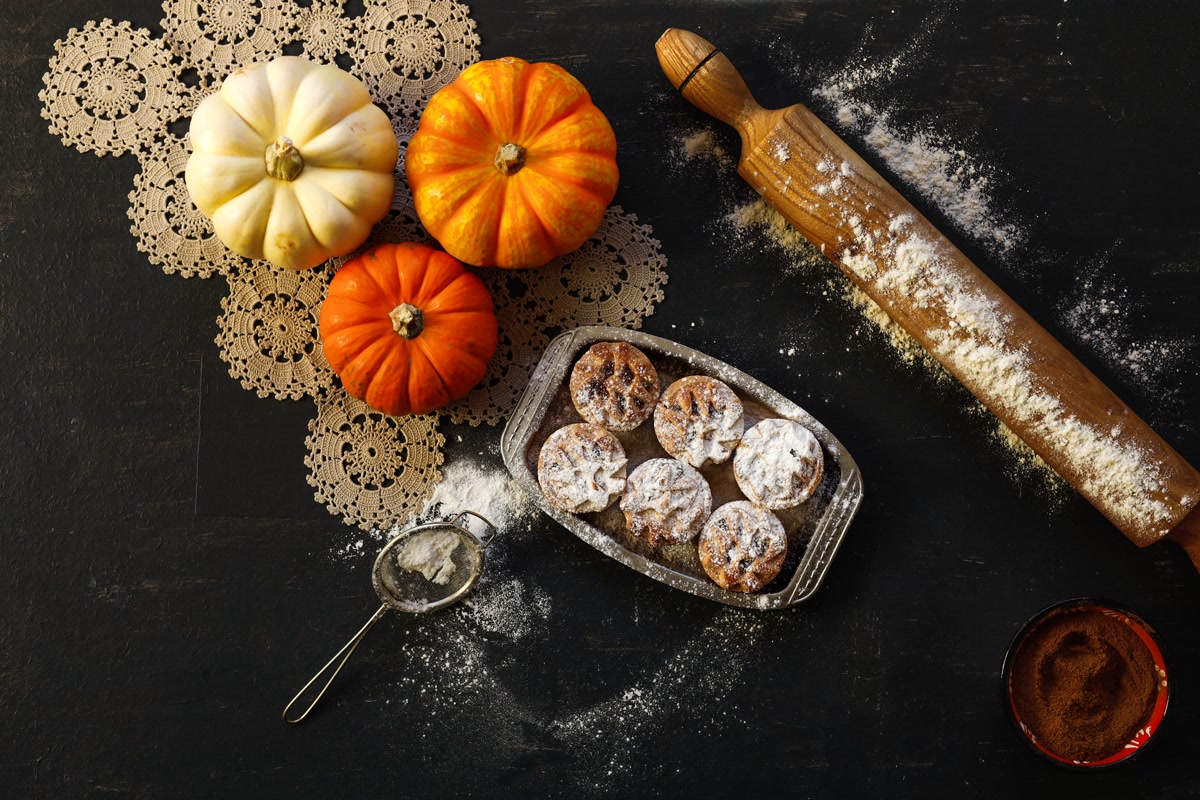 Baking ingredients for homemade dog treats including pumpkin flour and rolling pin