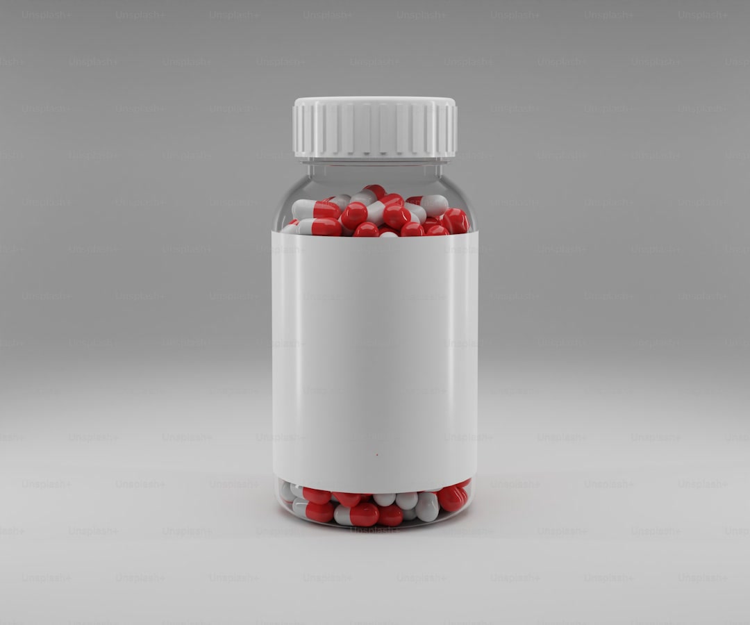 a pill bottle filled with red and white pills